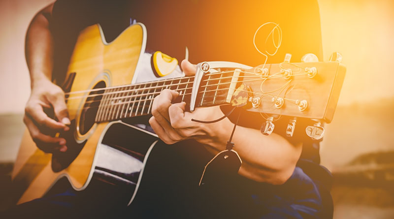 Playing acoustic guitar