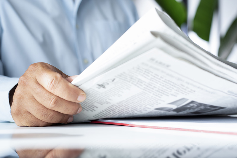 businessman reading newspaper at office