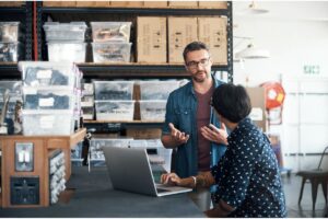 Shot of a man and woman having a discussion in a workshop