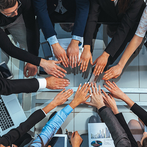 Top view of business team joining hands in a circle stock photo