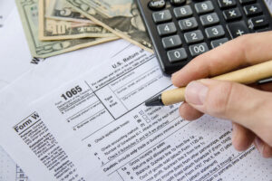 IRS forms with a pen, calculator, and US dollars stock photo