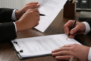 Law and justice. Lawyers working with documents at wooden table, closeup - stock photo