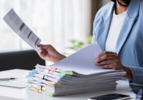 Business documents businessman check legal document review Prepare documents or analysis reports, tax items, accounting documents, data contracts, office partner agreements. - stock photo