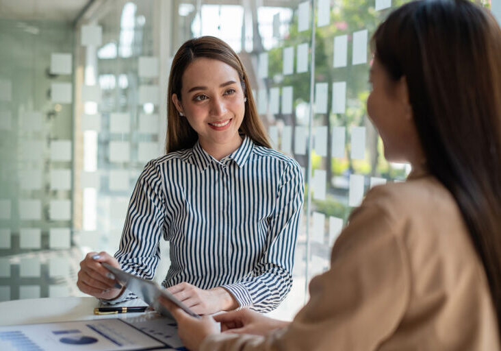 Two people having a discussion in an office setting